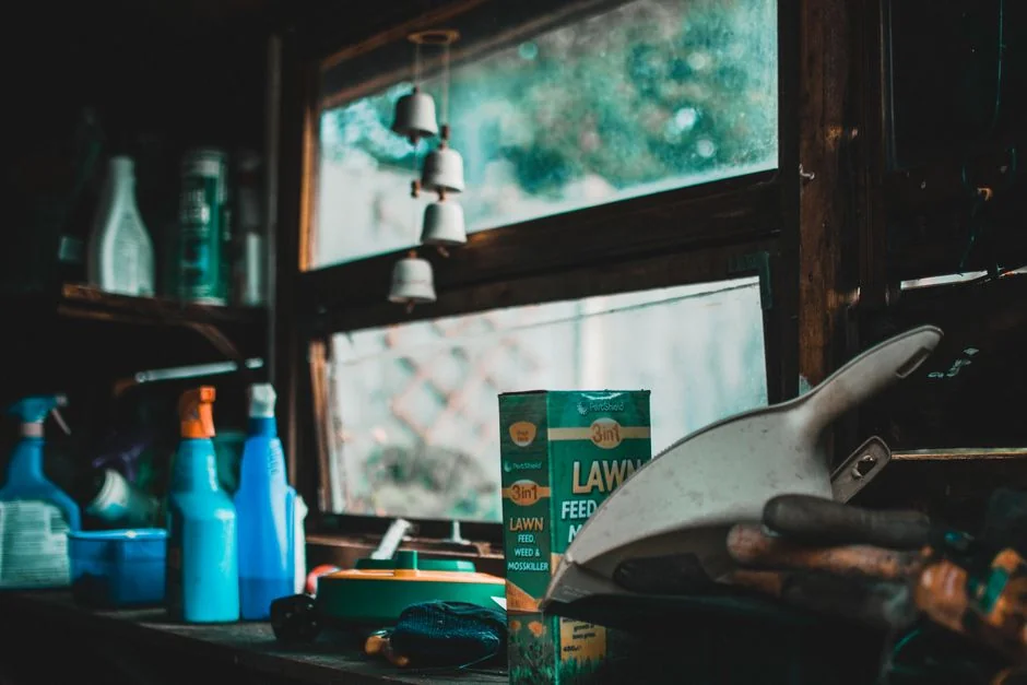 Person using spray bottle and cloth for cleaning a kitchen shelf, ensuring hygiene and cleanliness.